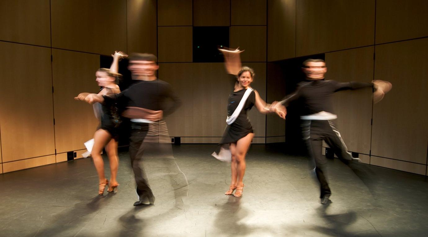 four students dance on the Benson Auditorium stage