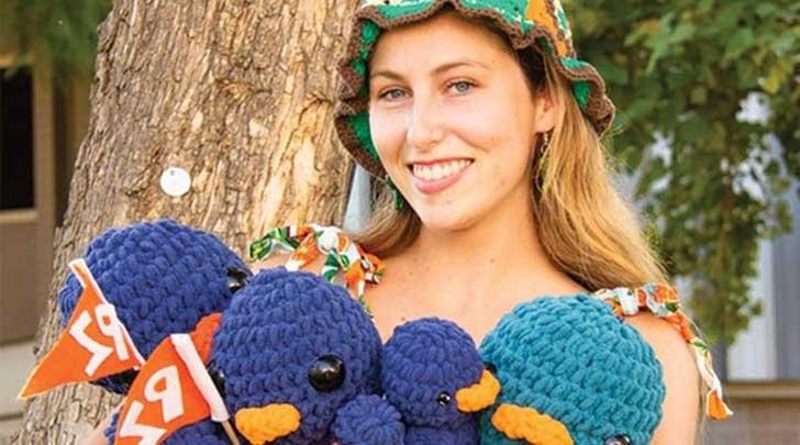 Lucy conover poses with the crocheted cecil the sagehens she created