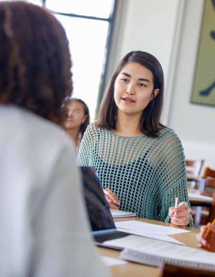 Seated student listens on study group.